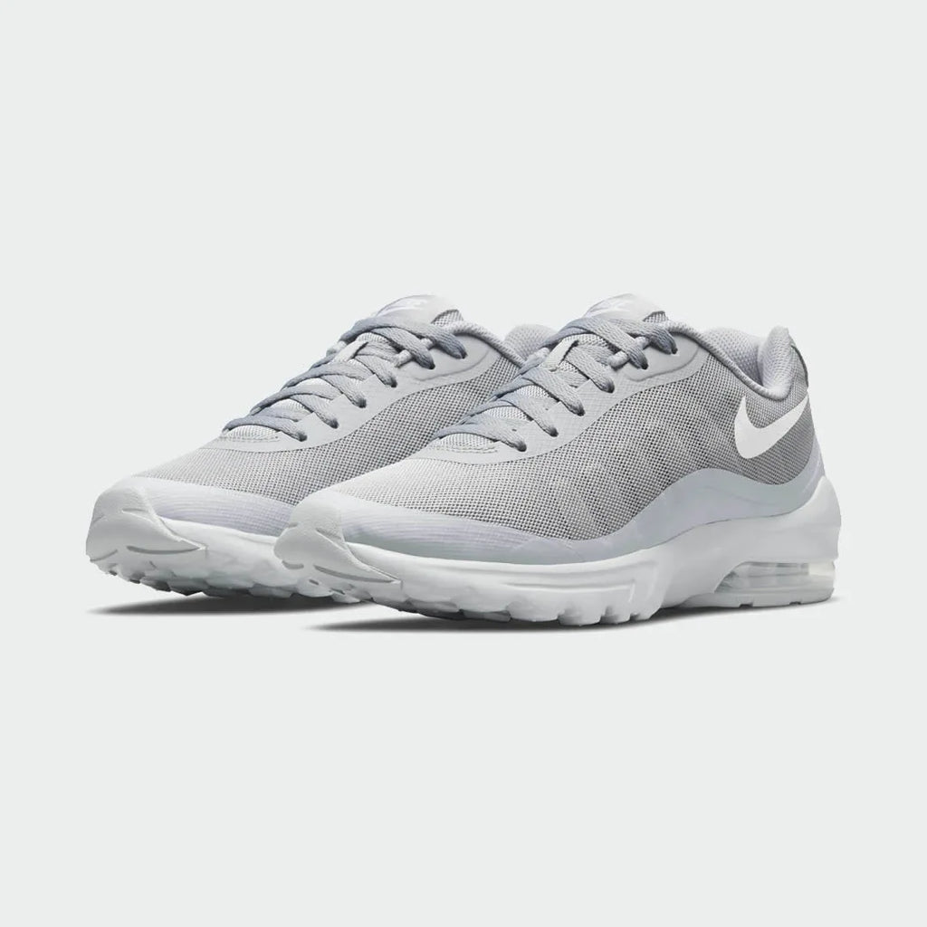 Angled view of two Nike Air Max Invigor Men's grey trainers, side by side, showcasing their modern aesthetic and lightweight construction.