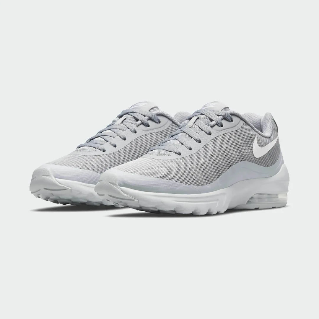 Angled view of two Nike Air Max Invigor Men's grey trainers, side by side, showcasing their modern aesthetic and lightweight construction.