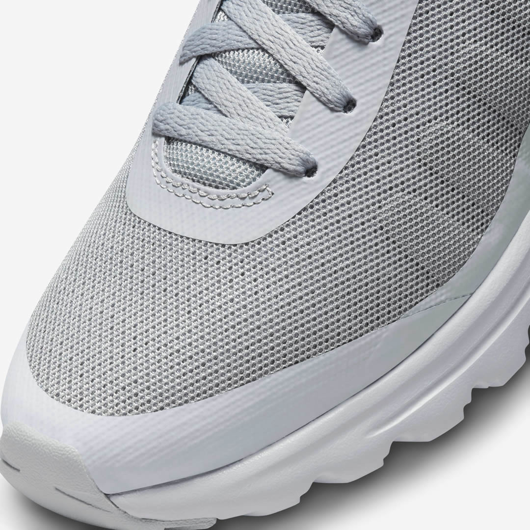 Close-up zoom on the front of the Nike Air Max Invigor Men's grey trainers, showing the mesh toe box, lacing system, and synthetic overlays.