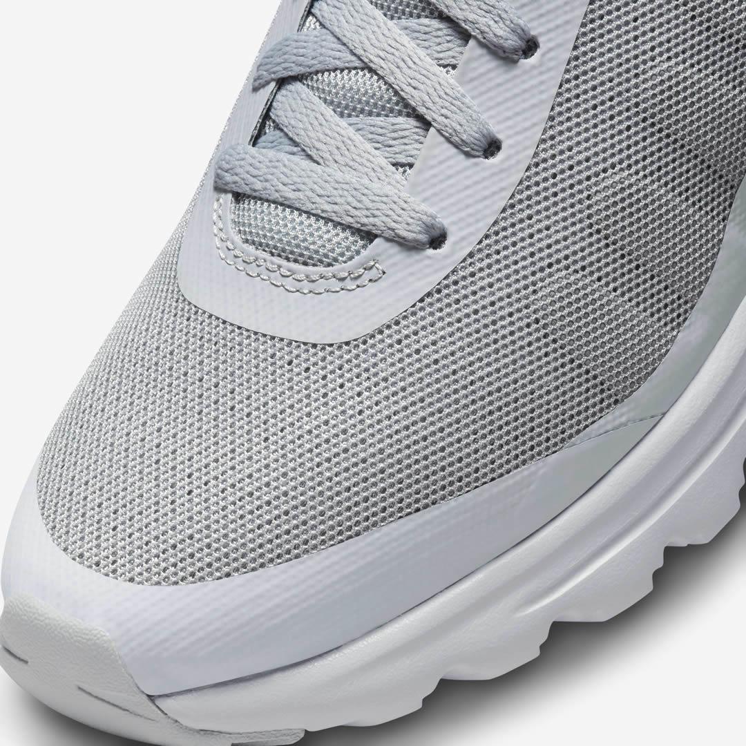 Close-up zoom on the front of the Nike Air Max Invigor Men's grey trainers, showing the mesh toe box, lacing system, and synthetic overlays.