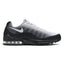 Capturing the streamlined road running silhouette, detailing the midnight navy engineered knit upper, white lateral Swoosh logo, external visible Achilles heel puffs, sculpted white foam midsole carrier, and dark rubber outsole profile.