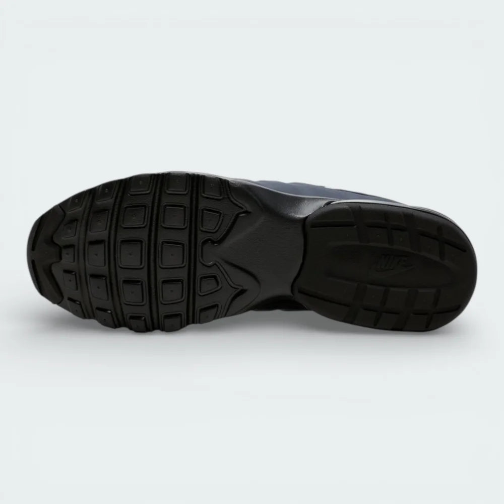 View of the black rubber outsole, showcasing the waffle-inspired traction pattern for multi-surface grip.