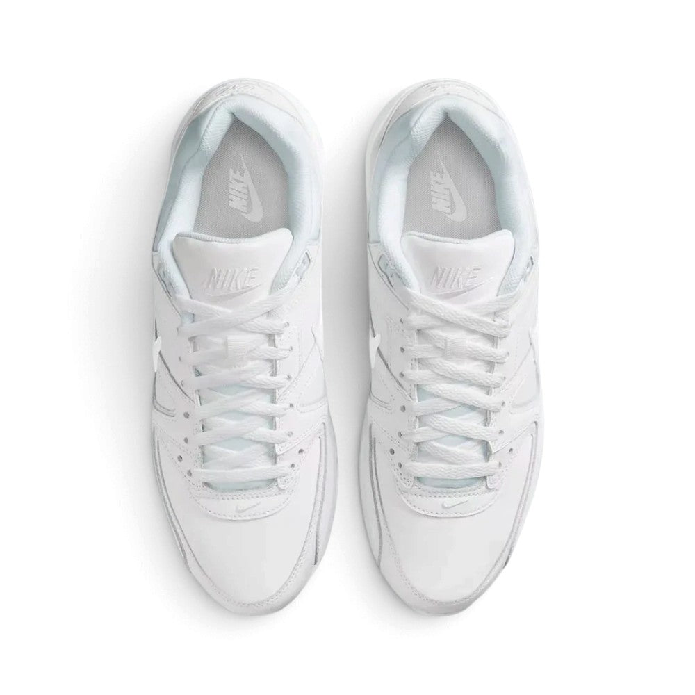Direct overhead view of both shoes laid flat, showcasing the clean white toe boxes, flat white laces threaded through reinforced eyestays, padded tongues with Nike branding, and cushioned interior footbeds.