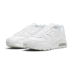 Forward three-quarter angle showcasing both shoes side by side, highlighting the classic retro running stance, premium leather sheen, tonal white colourway, and sturdy sole construction.