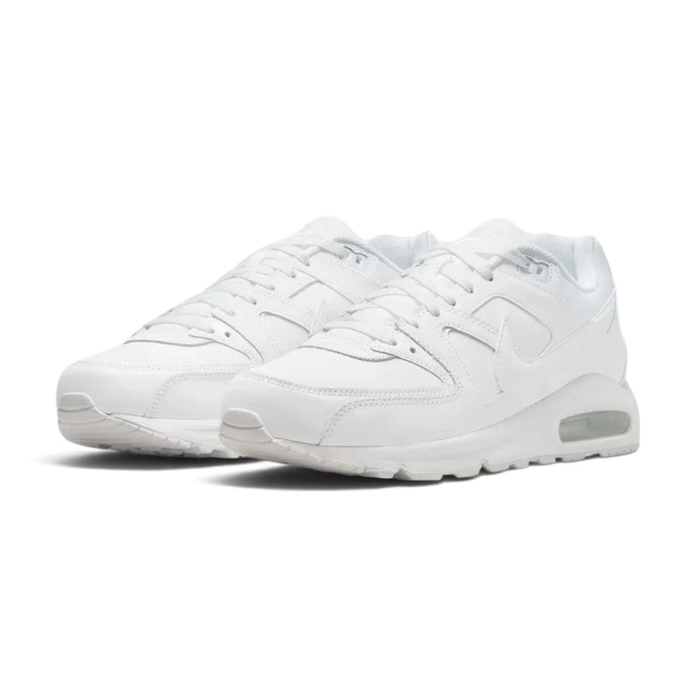 Forward three-quarter angle showcasing both shoes side by side, highlighting the classic retro running stance, premium leather sheen, tonal white colourway, and sturdy sole construction.