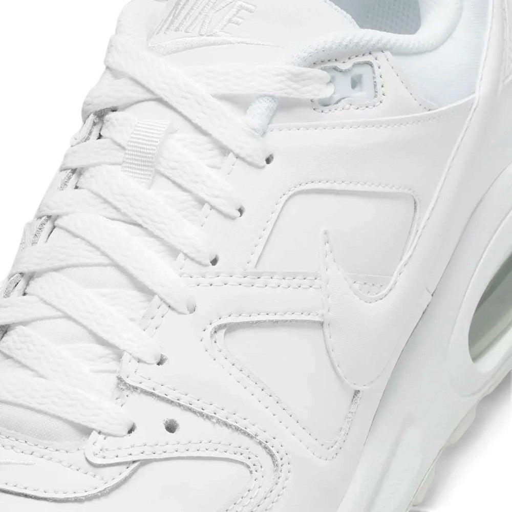 Macro focus on the forefoot and eyestay, detailing the fine leather grain, double-needle stitch lines along the overlay panels, and the clean lace eyelets.