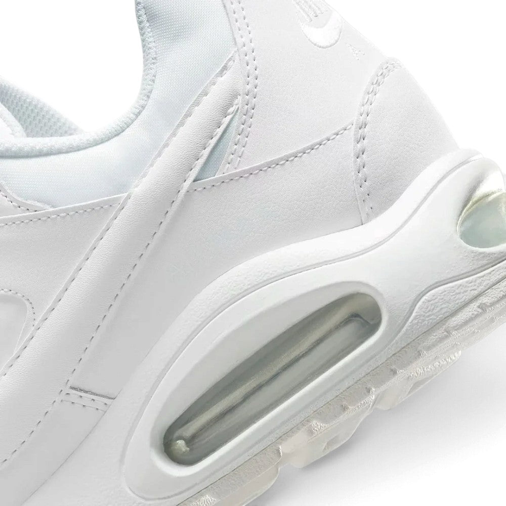 Macro view of the lateral heel transition, highlighting the cellular structure of the visible Max Air window and the durable textured rubber tread wrapping the sole rim.