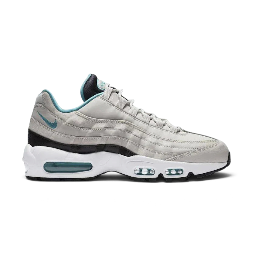 Nike Air Max 95 Essential Men's running shoes in beige with turquoise and black accents, side profile showing visible Max Air units in the heel and forefoot, and a layered upper.