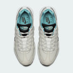 Top-down view of a pair of Nike Air Max 95 Essential Men's running shoes in beige, highlighting their iconic silhouette and lacing system.