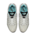 Top-down view of a pair of Nike Air Max 95 Essential Men's running shoes in beige, highlighting their iconic silhouette and lacing system.