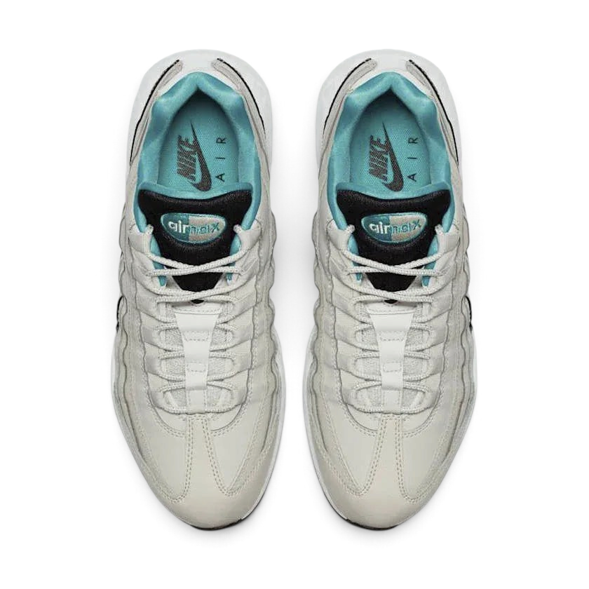 Top-down view of a pair of Nike Air Max 95 Essential Men's running shoes in beige, highlighting their iconic silhouette and lacing system.