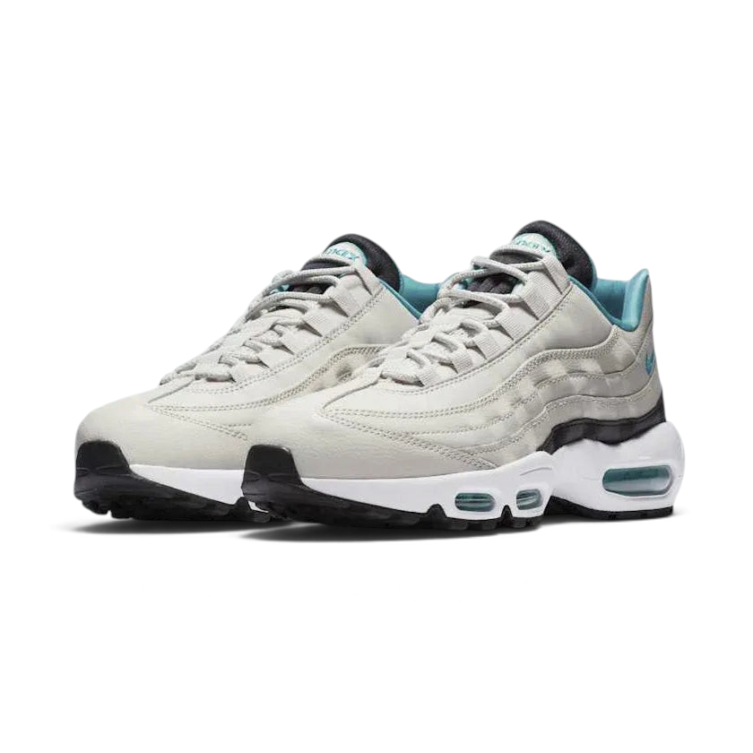 Angled view of two Nike Air Max 95 Essential Men's running shoes in beige, turquoise, and black, side by side, showcasing their timeless design and layered upper.