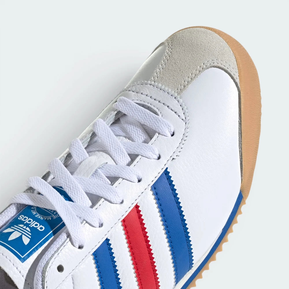 Details the premium dual-stitching lines crossing the velvety suede toe guard and the precision lace eyelet configuration.
