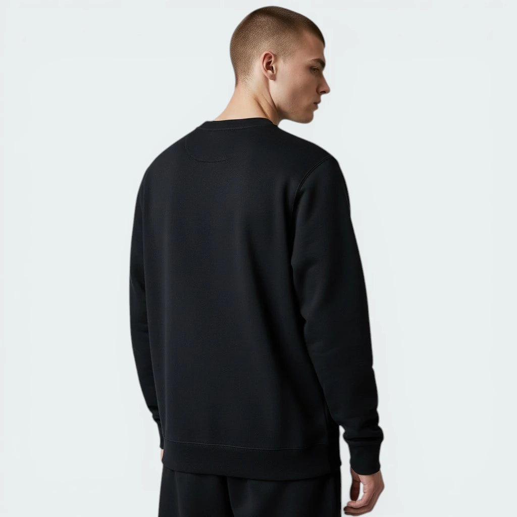 Person wearing a black sweatshirt on a light gray background