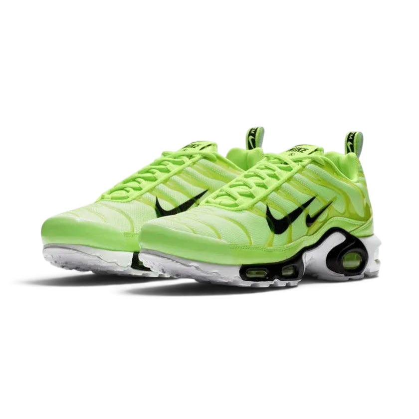 Angled view of two Nike Air Max Plus Men's "Lime Blast" trainers, side by side, emphasizing the vibrant colour scheme and Tuned Air technology.