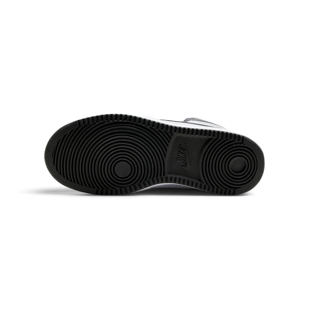Bottom-down view of the black rubber outsole, showcasing the concentric circular pivot-point tread pattern and classic Nike branding embedded at the arch.