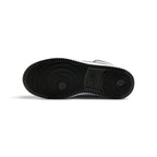 Bottom-down view of the black rubber outsole, showcasing the concentric circular pivot-point tread pattern and classic Nike branding embedded at the arch.