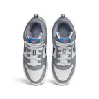 Overhead top-down view looking down at the laced sneakers, displaying the white flat laces, textile tongue with blue and orange branding tags, and cushioned grey collar openings.
