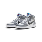 Angled front-three-quarter perspective capturing the layered synthetic leather overlays, perforated forefoot ventilation, and dark side branding.