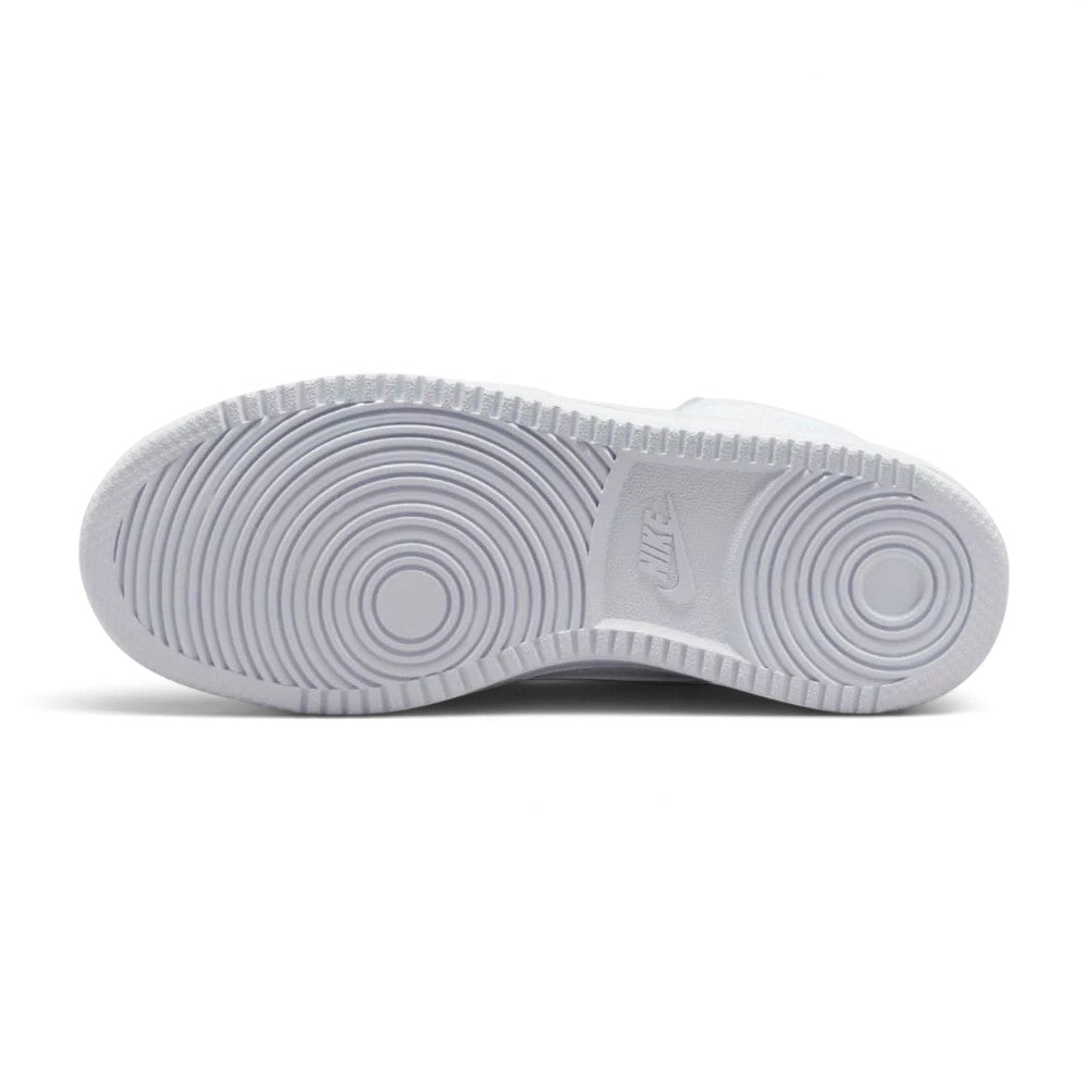 Full-length bottom profile showing the solid white rubber cupsole, displaying the forefoot and heel concentric circular pivot patterns, perimeter traction blocks, and central recessed Nike block lettering.