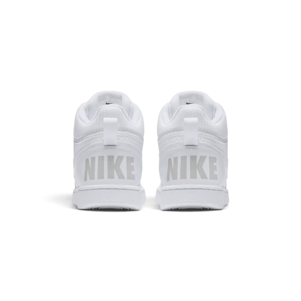 Close-up rear angle focusing on both heel counters, showcasing the bold tonal "NIKE" block lettering, vertical leather overlay, webbed pull loops, and thick padded collar rim.