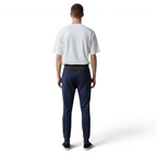 Man wearing a white t-shirt and navy pants on a white background