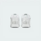 Rear view of the trainers, focusing on the "NIKE" branding on the heel and the padded ankle collar.