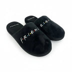 Black slippers with 'FRIENDS' text on a white background