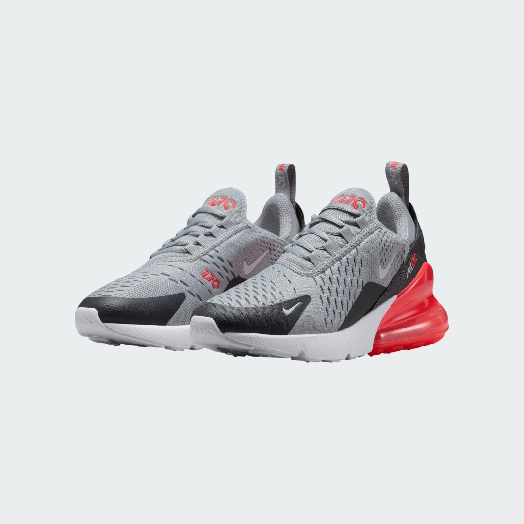 Angled view of two Nike Air Max 270 Juniors' trainers in grey, side by side, showcasing their bold design and visible Air unit.