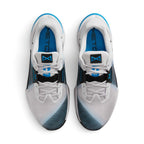 Aerial top-down view of both trainers, showing the grey mesh uppers, matching laces, blue cushioned insoles with Metcon branding, black lace bands, and blue tongue badge logos.