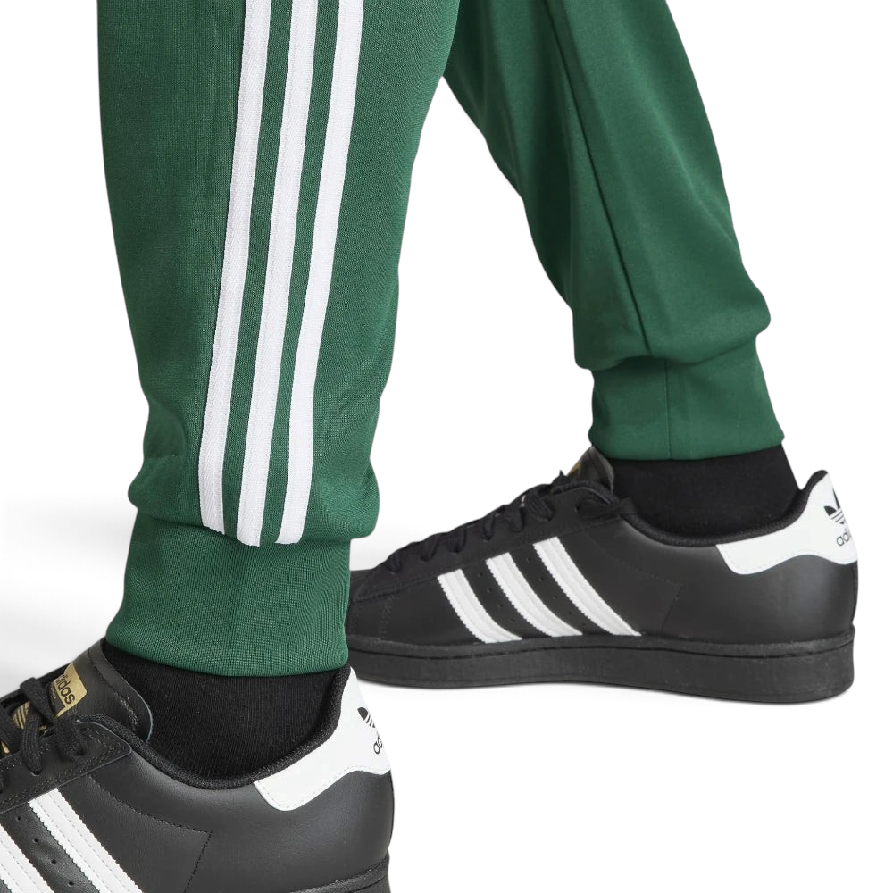 Highlighting the texture of the ribbed ankle cuffs and the high-quality white-on-green finish.