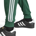 Highlighting the texture of the ribbed ankle cuffs and the high-quality white-on-green finish.