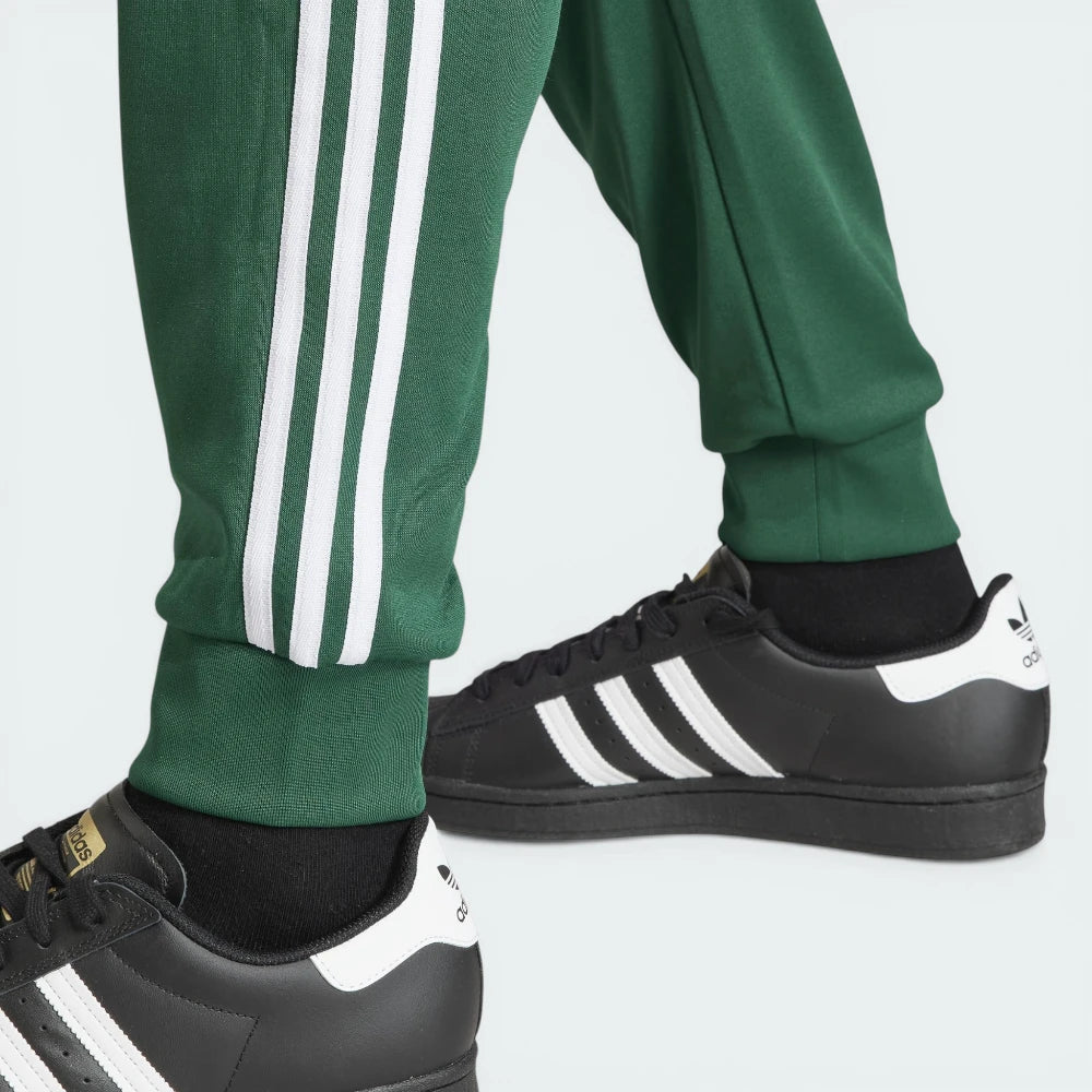 Highlighting the texture of the ribbed ankle cuffs and the high-quality white-on-green finish.