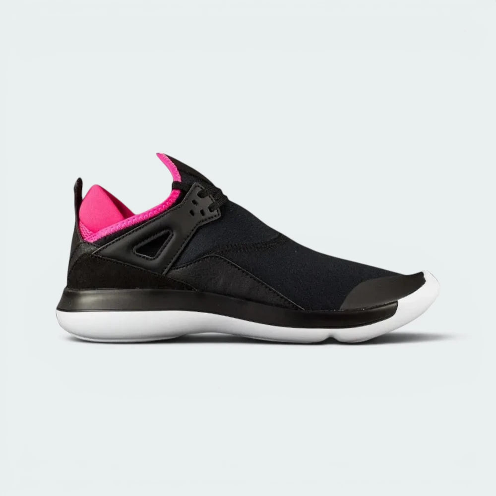 Highlights the high-velocity lines of the black neoprene bootie upper, showing the professional integration of the iconic Jordan 4 side wings and the clean white foam midsole cutting across the hyper pink accents.