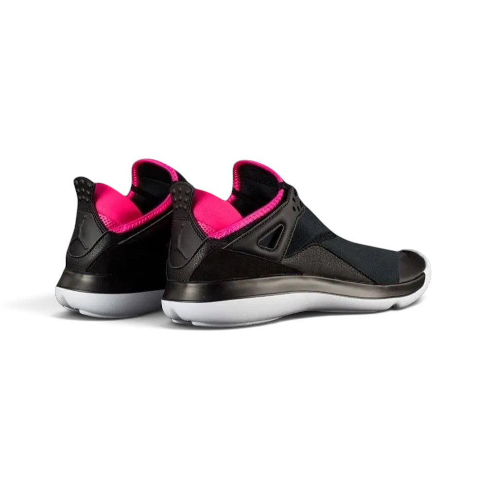 Focuses on the contoured shape of the extended AJ4 heel tab, showcasing the high-definition speckling covering the pull loop.