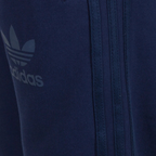 Close-up of a navy blue Adidas tracksuit with logo and zipper detail.