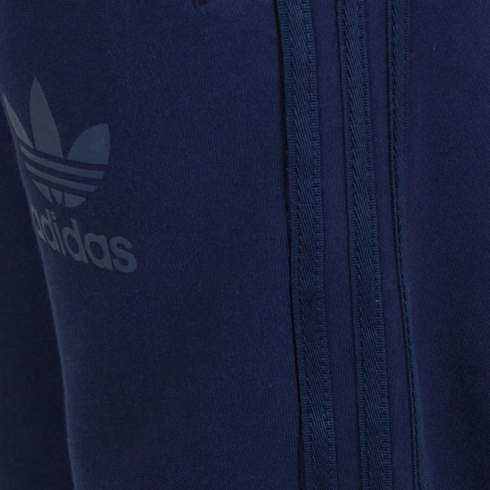 Close-up of a navy blue Adidas tracksuit with logo and zipper detail.