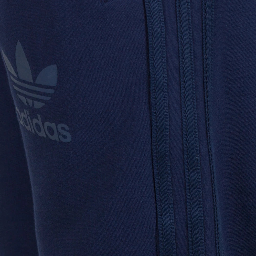 Close-up of a navy blue Adidas tracksuit with logo and zipper detail.