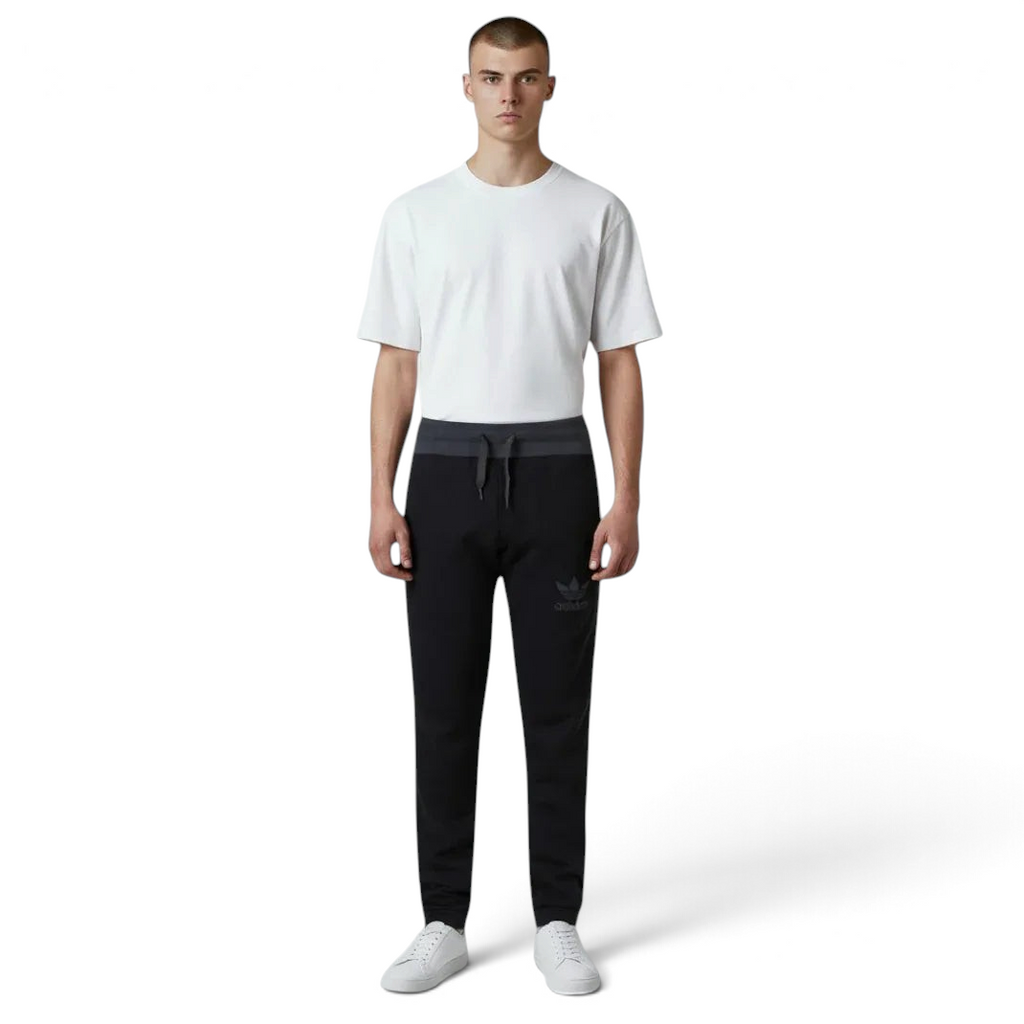 Highlights the high-velocity sweep of the contrast grey 3-Stripes along the side seams, showing the professional, deep matte black texturing of the French terry body and the clean alignment of the Trefoil logo.