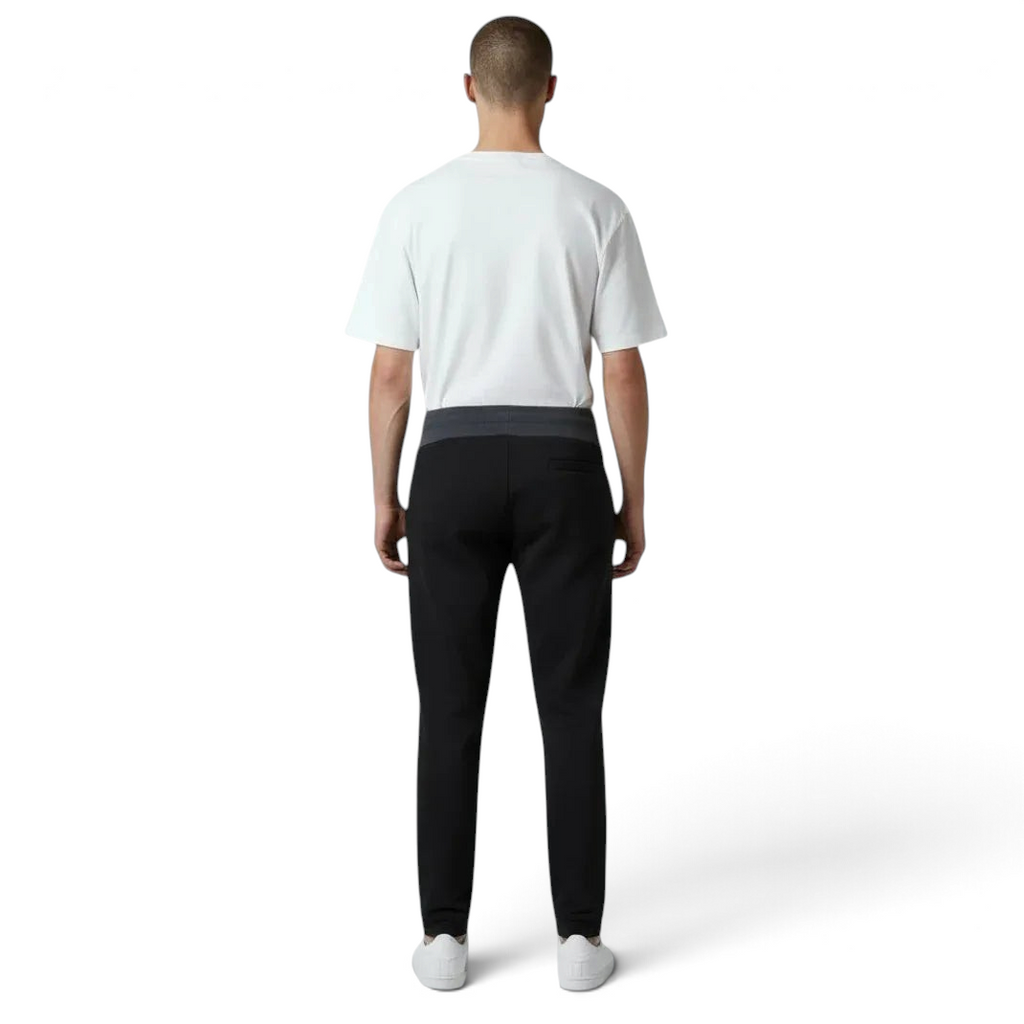 Person wearing a white t-shirt and black pants on a white background