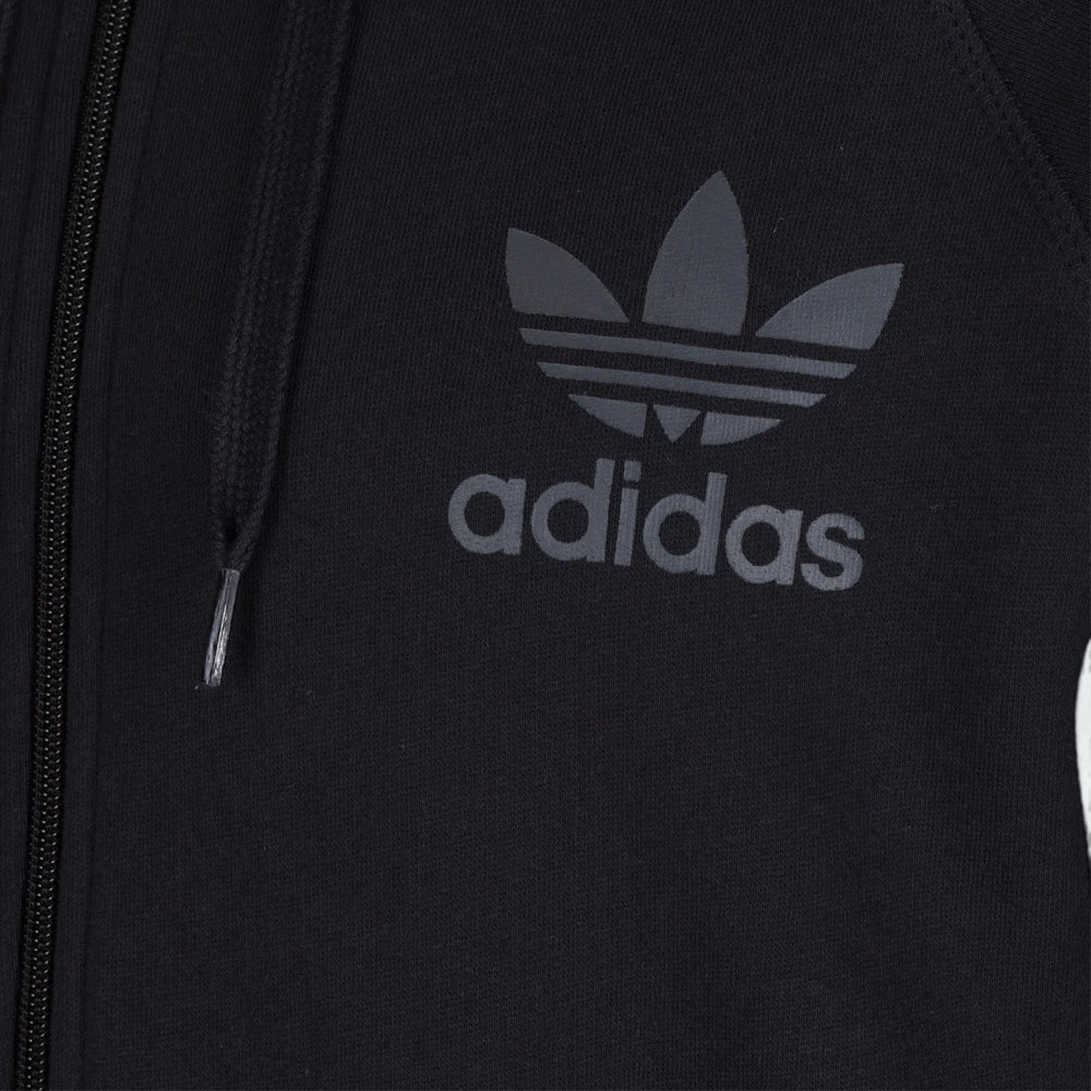 A close-up of the high-definition screen-printed Trefoil logo and the technical grain of the fabric.
