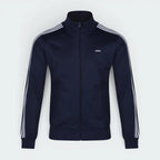Highlights the high-velocity sweep of the continuous crisp White 3-Stripes tracking cleanly down the Navy blue arm, showing the professional, texturized weave of the heavyweight piqué fabric blend.