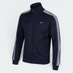 Focuses on the symmetry of the flat-laid track jacket, displaying the perfect alignment of the high stand-up collar, the white zip track, and the balance of the embroidered Trefoil logo.