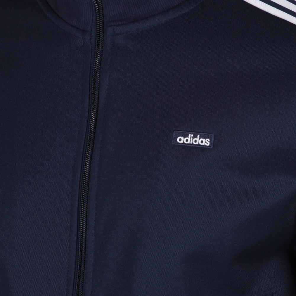 Details the premium precision of the high-density embroidery tracking across the classic Trefoil chest logo and the neat configuration of the main zipper teeth.