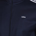 Details the premium precision of the high-density embroidery tracking across the classic Trefoil chest logo and the neat configuration of the main zipper teeth.