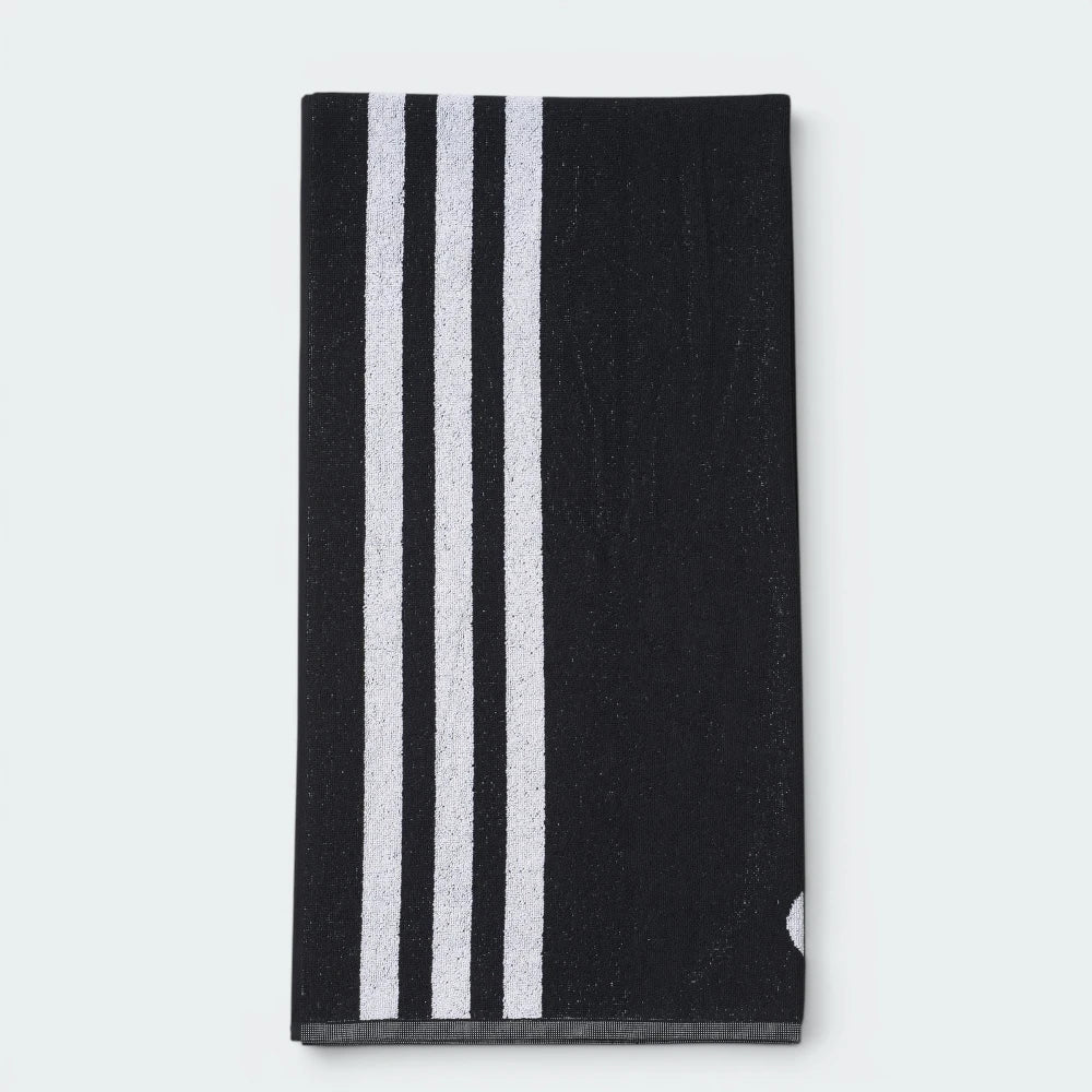Focuses on the reverse folded side of the towel, showcasing the three clean, vertical white 3-Stripes tracking down the left edge against the solid black cotton canvas.