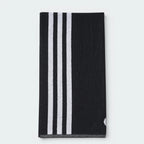 Focuses on the reverse folded side of the towel, showcasing the three clean, vertical white 3-Stripes tracking down the left edge against the solid black cotton canvas.