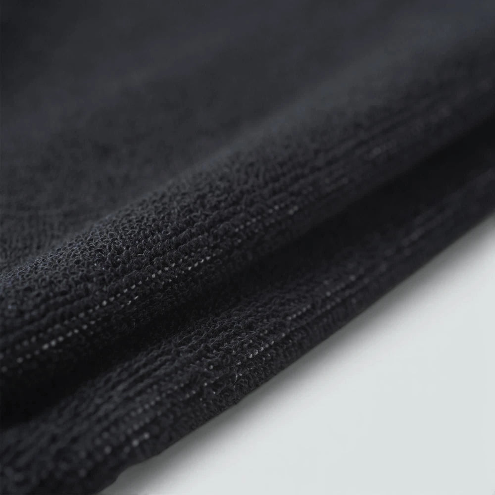 Displays a close-up of the blank black terry loop area when folded, showcasing the deep, comfortable pile of the weave engineered for maximum moisture absorption.
