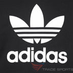 A close-up of the high-definition screen-printed Trefoil logo and the technical grain of the fabric.