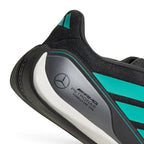 Macro focus on the metallic heel counter featuring the official team typography and the iconic Mercedes three-pointed star emblem.